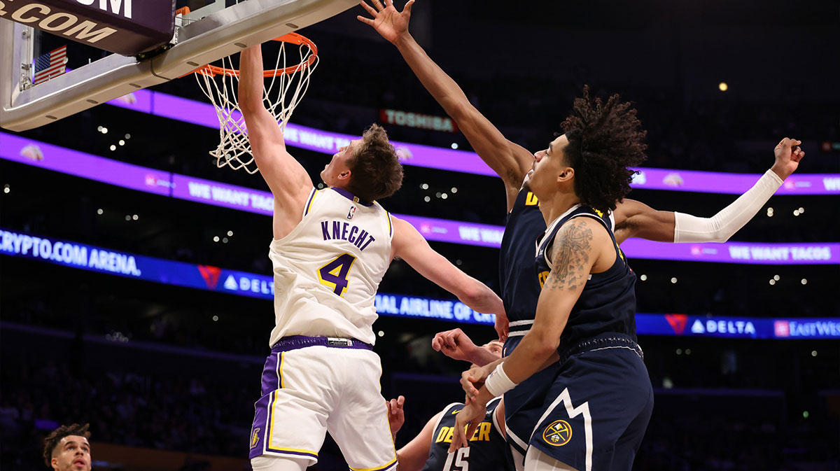 Los Angeles Lakers guard Dalton Knecht (4) shoots the ball past Denver Nuggets guard Julian Strawther (3) during the third quarter at Crypto.com Arena.