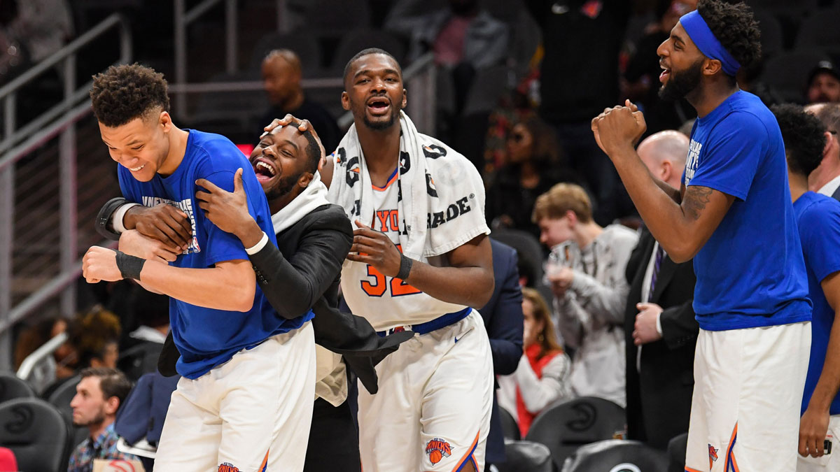 New York Knicks players including forward Kevin Knox (20) (left) and forward Noah Vonleh (32) (center) react after defeating the Atlanta Hawks at State Farm Arena. 