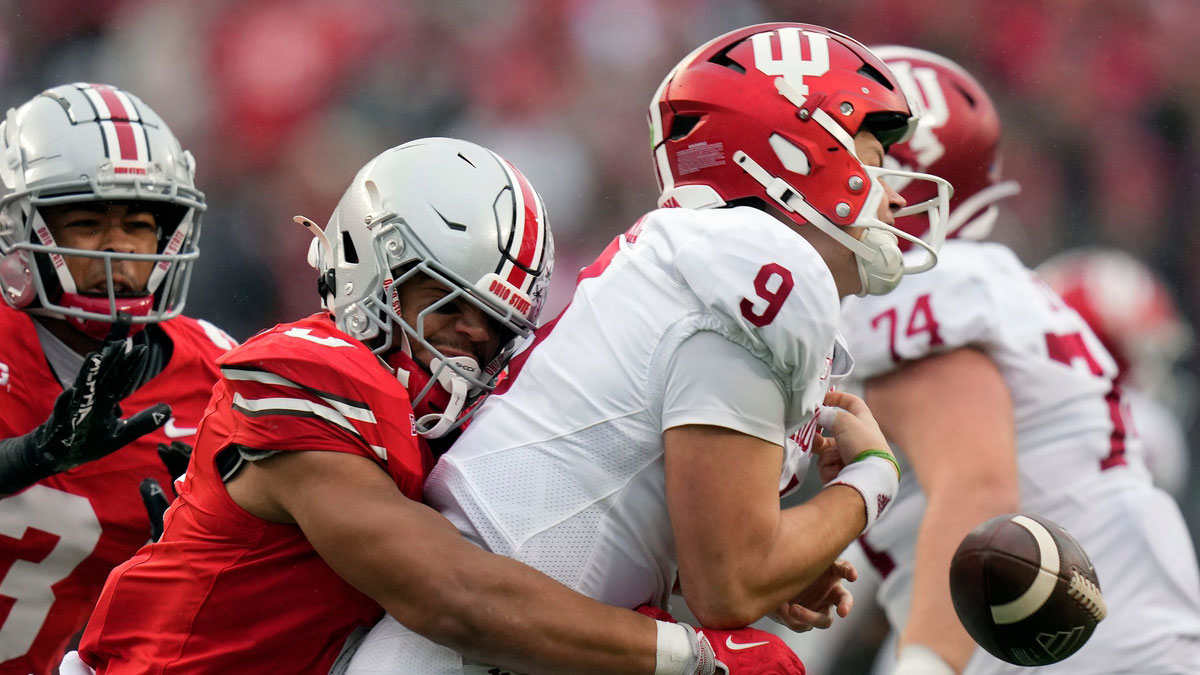 Ohio State Buckeyes linebacker Cody Simon (0) knocks the ball out of the hands of Indiana Hoosiers quarterback Kurtis Rourke (9) for a fumble that Ohio State recovered during the second quarter of the football game in Columbus on Saturday, Nov. 23, 2024.