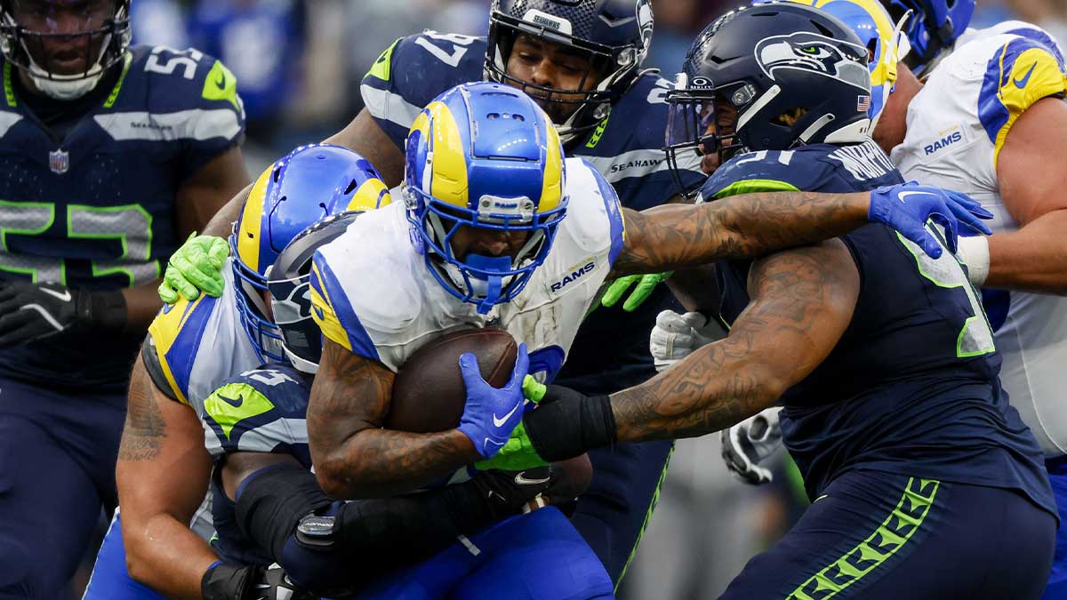Los Angeles Rams running back Kyren Williams (23) rushes against Seattle Seahawks defensive tackle Byron Murphy II (91) and defensive tackle Johnathan Hankins (97) during the third quarter at Lumen Field.