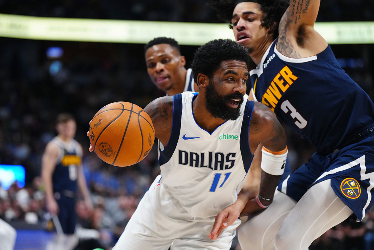 Dallas Mavericks Guard Kirie Irving (11) Run around Denver Nuggets Guard Julian Strawher (3) in the second half at Balli Arena. 