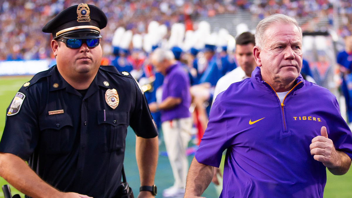 LSU Tigers head coach Brian Kelly runs off the field after the first half at Ben Hill Griffin Stadium in Gainesville, FL