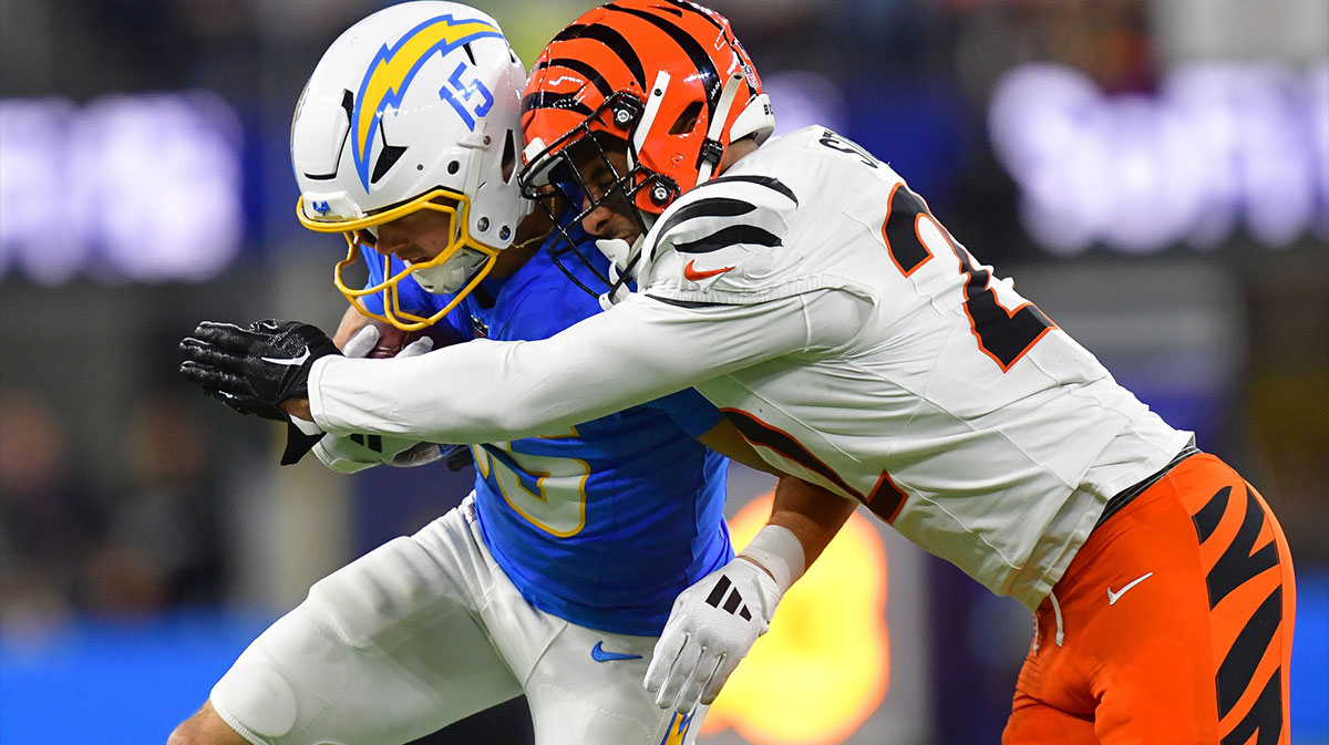 Los Angeles Chargers wide receiver Ladd McConkey (15) runs the ball against Cincinnati Bengals safety Geno Stone (22) during the first half at SoFi Stadium