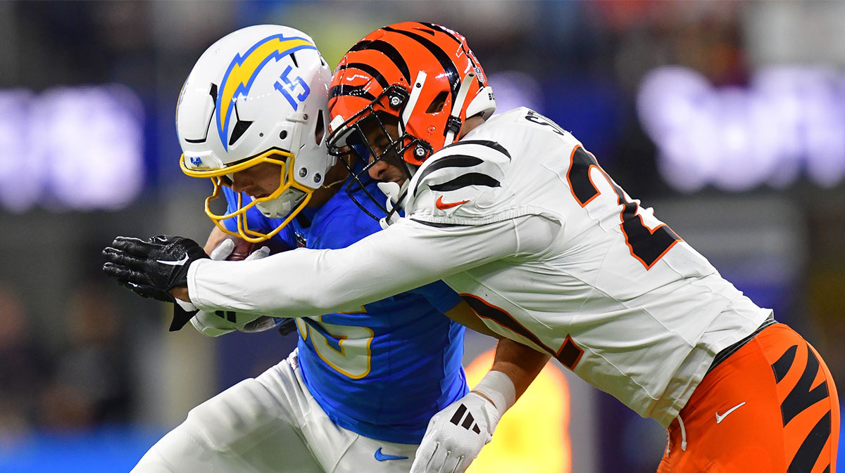 Los Angeles Chargers wide receiver Ladd McConkey (15) runs the ball against Cincinnati Bengals safety Geno Stone (22) during the first half at SoFi Stadium.