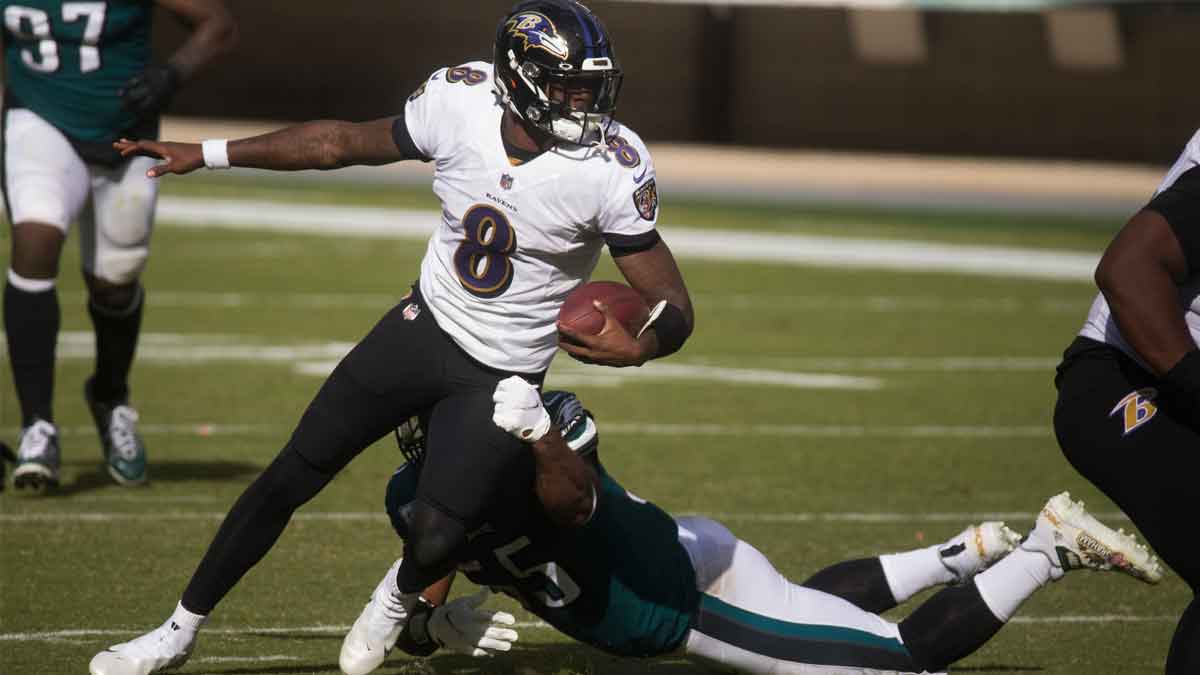 Baltimore's Lamar Jackson (8) breaks a tackle as he looks for a path to run Sunday, Oct. 18, 2020, at Lincoln Financial Field. The Eagles were defeated by the Baltimore Ravens 30-28. Sports Eagles Ravens