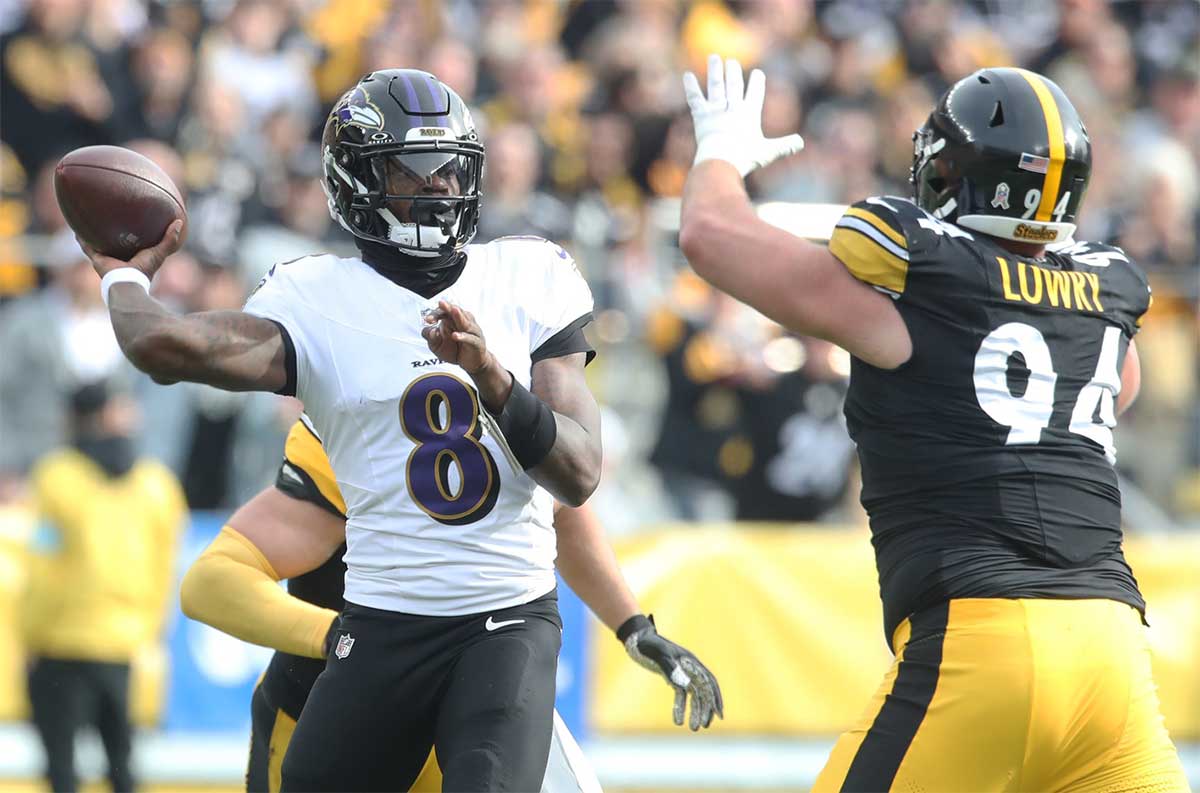 Baltimore Ravens quarterback Lamar Jackson (8) passes against pressure from Pittsburgh Steelers defensive tackle Dean Lowry (94) during the first quarter at Acrisure Stadium.
