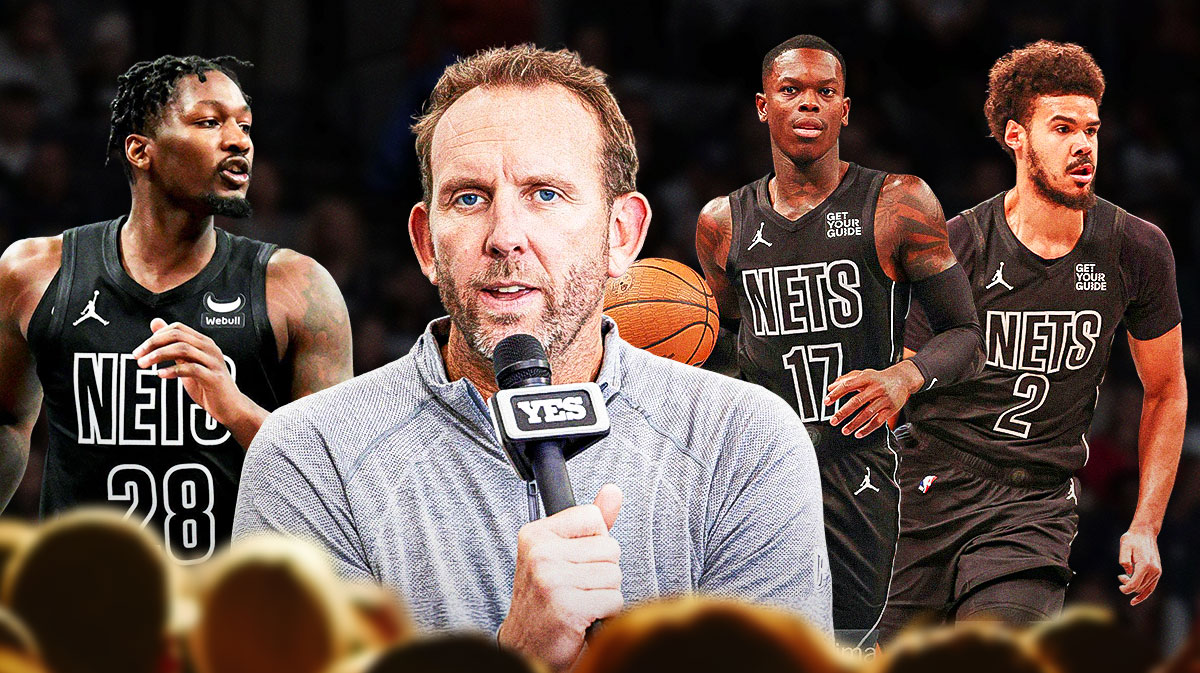 Sean Marks looking at a whiteboard with pictures of Cam Johnson, Dorian Finney-Smith, and Dennis Schrode