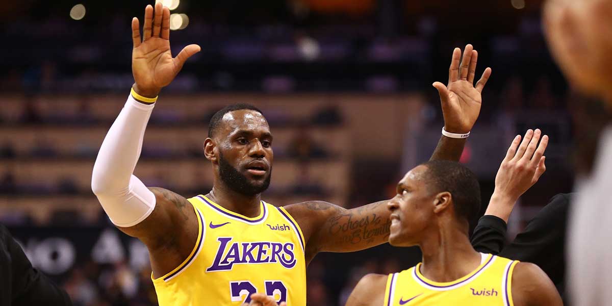 Los Angeles Lakers forward LeBron James (23) celebrates with guard Rajon Rondo (9) against the Phoenix Suns at Talking Stick Resort Arena. Mandatory Credit: Mark J. Rebilas-Imagn Images