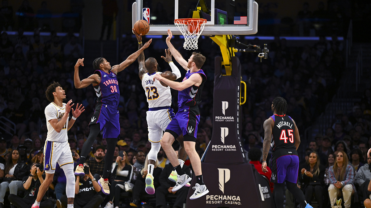 Los Angeles Lakers forward LeBron James (23) shoots against Toronto Raptors guard Ochai Agbaji (30) and center Jakob Poeltl (19) during the second half at Crypto.com Arena.