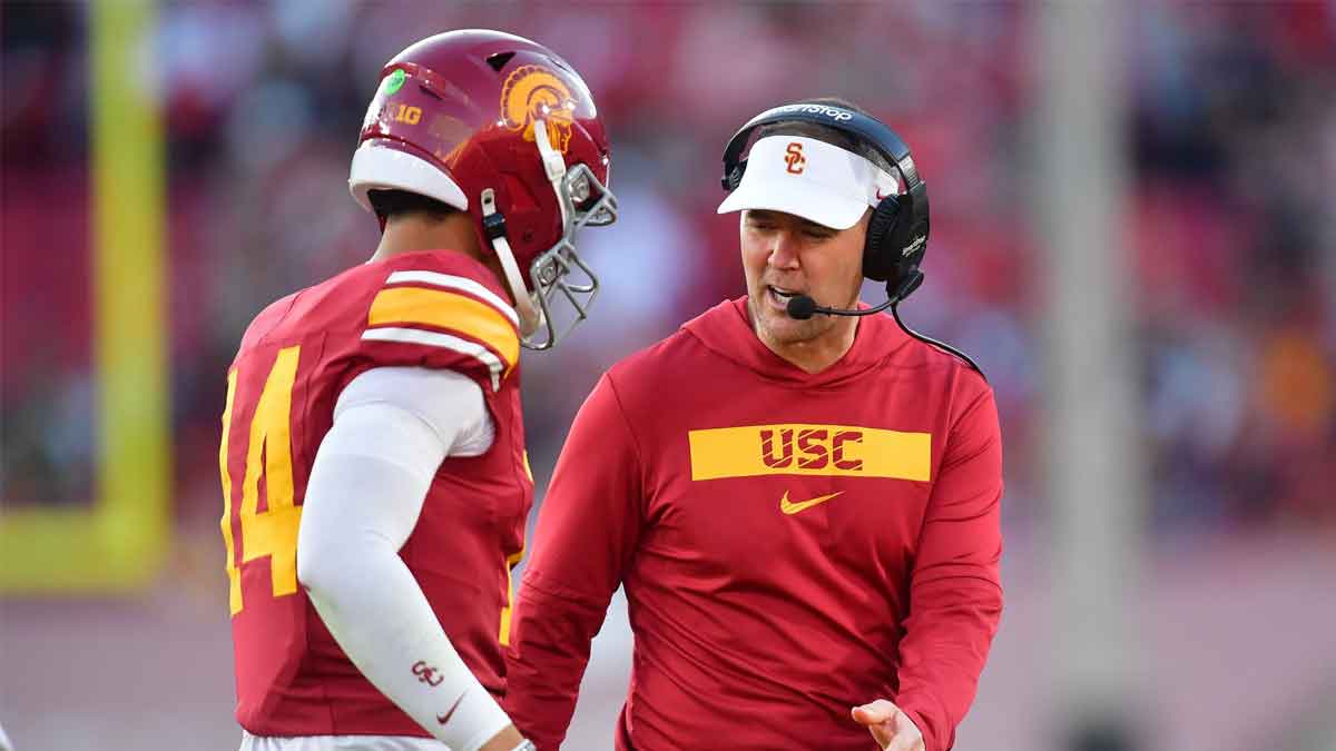 USC Southern California Trojans head coach Lincoln Riley greets quarterback Jayden Maiava (14) after scoring a touchdown against the Nebraska Cornhuskers during the second half at the Los Angeles Memorial Coliseum.