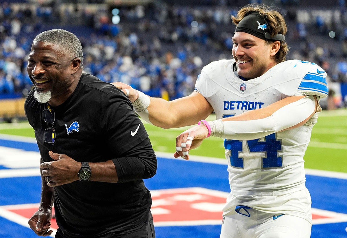 Detroit Lions defensive coordinator Aaron Glenn and linebacker Malcolm Rodriguez (44) celebrate 24-6 win over Indianapolis Colts as they exit the field at Lucas Oil Stadium in Indianapolis, Ind. on Sunday, Nov. 24, 2024.