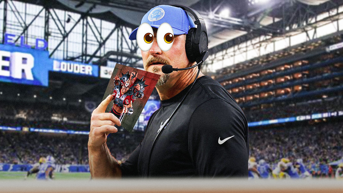 Detroit Lions head coach Dan Campbell with 👀 on his head, standing in front of Ford Field and holding up a picture of WWF duo "Road Warriors".