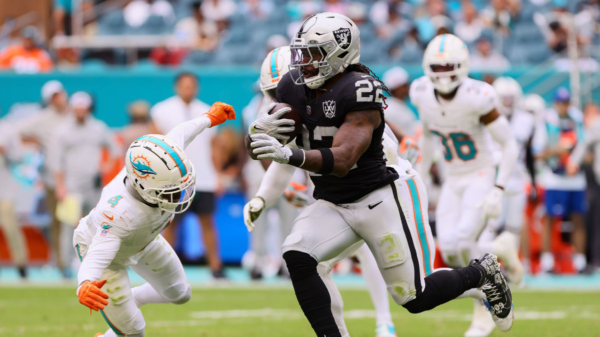 Las Vegas Raiders running back Alexander Mattison (22) runs with the football against Miami Dolphins cornerback Kader Kohou (4) during the fourth quarter at Hard Rock Stadium.