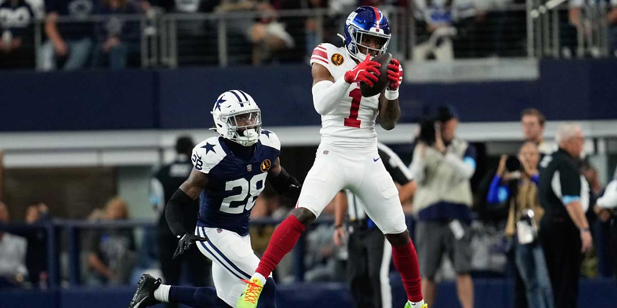 New York Giants wide receiver Malik Nabers (1) catches a pass as Dallas Cowboys safety Malik Hooker (28) gives chase during the first half at AT&T Stadium.