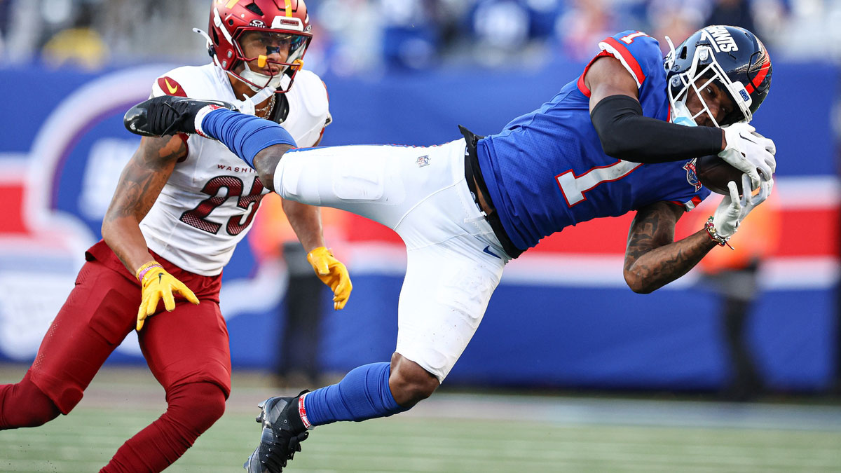 New York Giants wide receiver Malik Nabers (1) makes a catch in front of Washington Commanders cornerback Benjamin St-Juste (25) during the second half at MetLife Stadium.