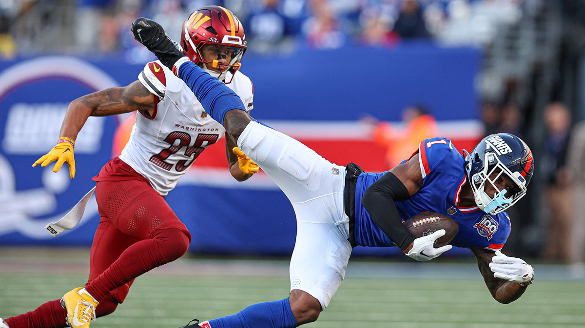 New York Giants wide receiver Malik Nabers (1) makes a catch in front of Washington Commanders cornerback Benjamin St-Juste (25) during the second half at MetLife Stadium.