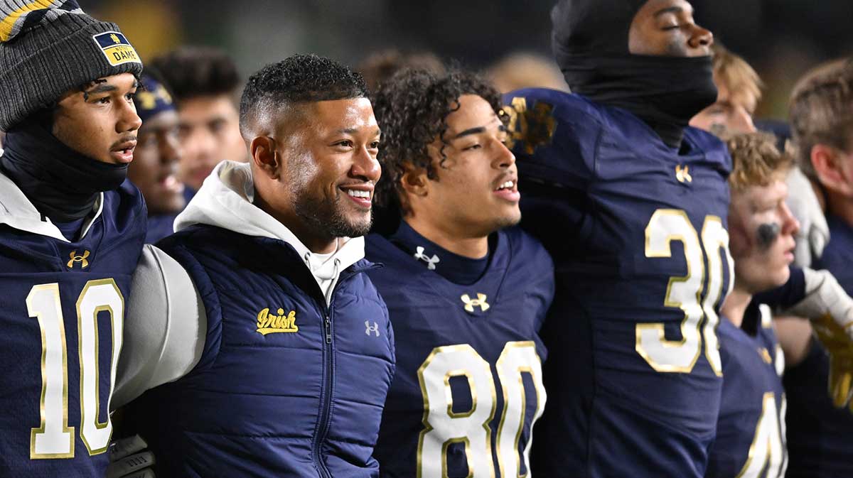 Notre Dame Fighting Irish head coach Marcus Freeman stands with his players for the Notre Dame Alma Mater after defeating the Florida State Seminoles at Notre Dame Stadium.