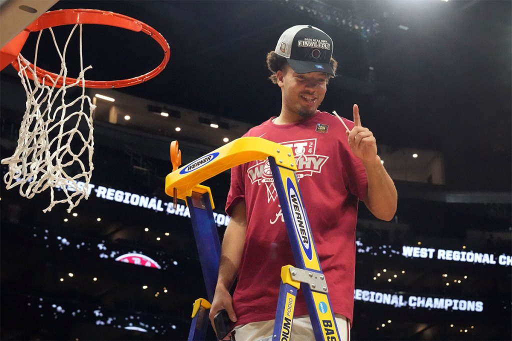 Alabama Crimson Tide guard Mark Sears (1) cuts the net after defeating the Clemson Tigers in the finals of the West Regional of the 2024 NCAA Tournament at Crypto.com Arena.