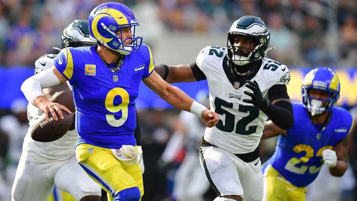 Los Angeles Rams quarterback Matthew Stafford (9) rolls out to pass under pressure from Philadelphia Eagles linebacker Zach Cunningham (52) during the second half at SoFi Stadium.