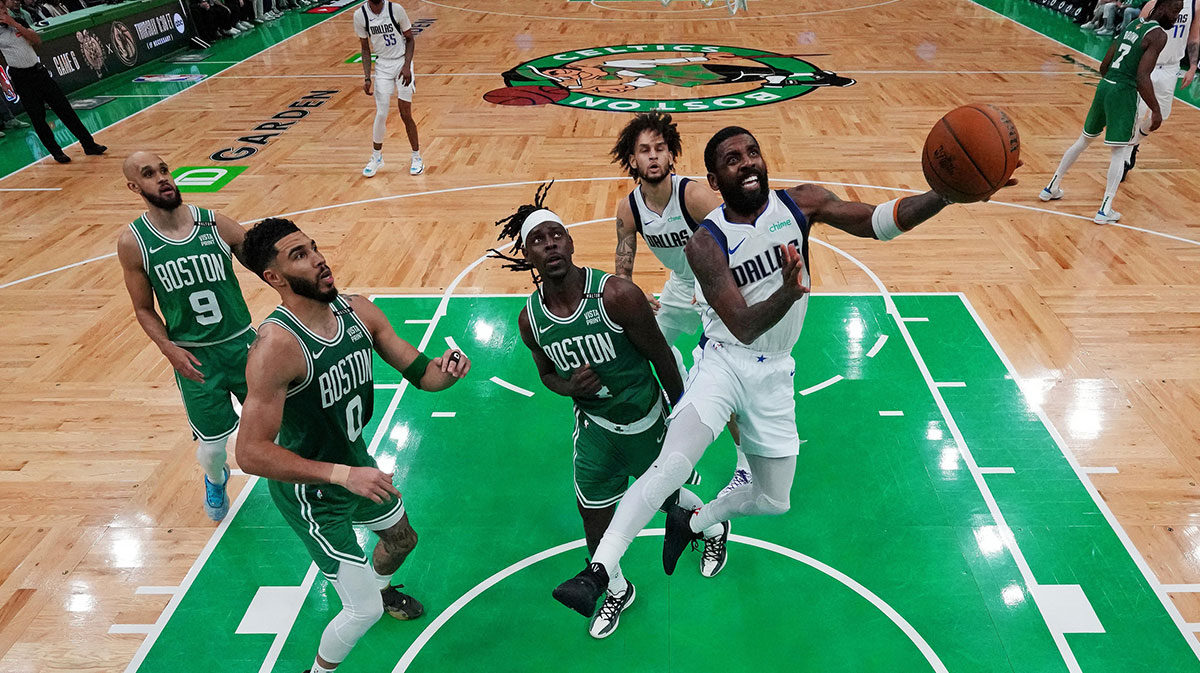 Dallas Mavericks guard Kyrie Irving (11) shoots the ball against Boston Celtics guard Jrue Holiday (4) in game five of the 2024 NBA Finals at TD Garden