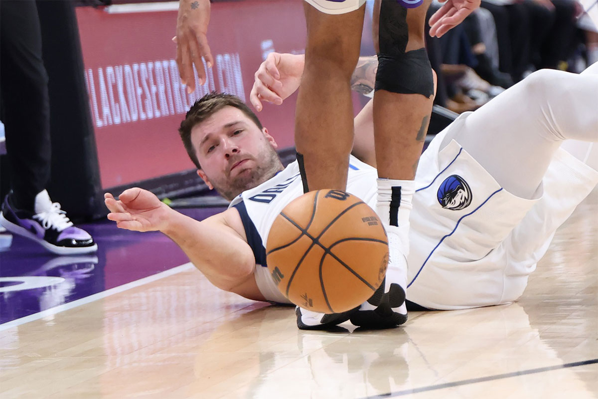 Dallas Mavericks guard Luka Doncic (77) goes to the floor for a ball against the Utah Jazz during the third quarter at Delta Center