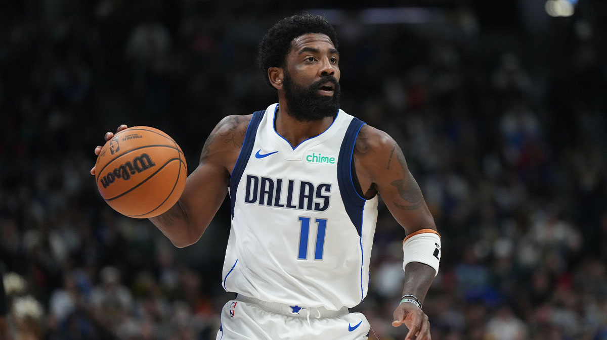 Dallas Mavericks guard Kyrie Irving (11) controls the ball during the second half against the Denver Nuggets at Ball Arena.