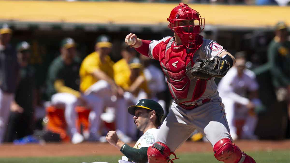Los Angeles Angels designated hitter Max Stassi (33) throws to first after forcing out Oakland Athletics center fielder Cal Stevenson (37) during the sixth inning at RingCentral Coliseum. Seth Brown was out at first base.