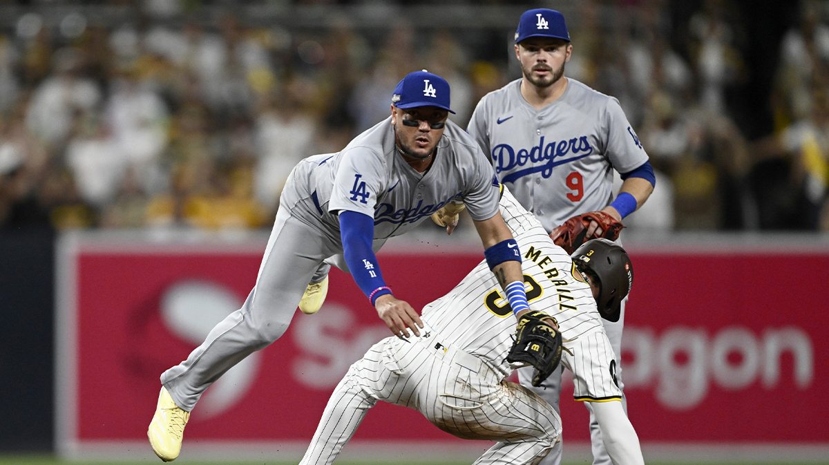 Oct 8, 2024; San Diego, California, USA; Los Angeles Dodgers shortstop Miguel Rojas (11) throws late to first after not forcing out San Diego Padres outfielder Jackson Merrill (3) at second in the second inning during game three of the NLDS for the 2024 MLB Playoffs at Petco Park.