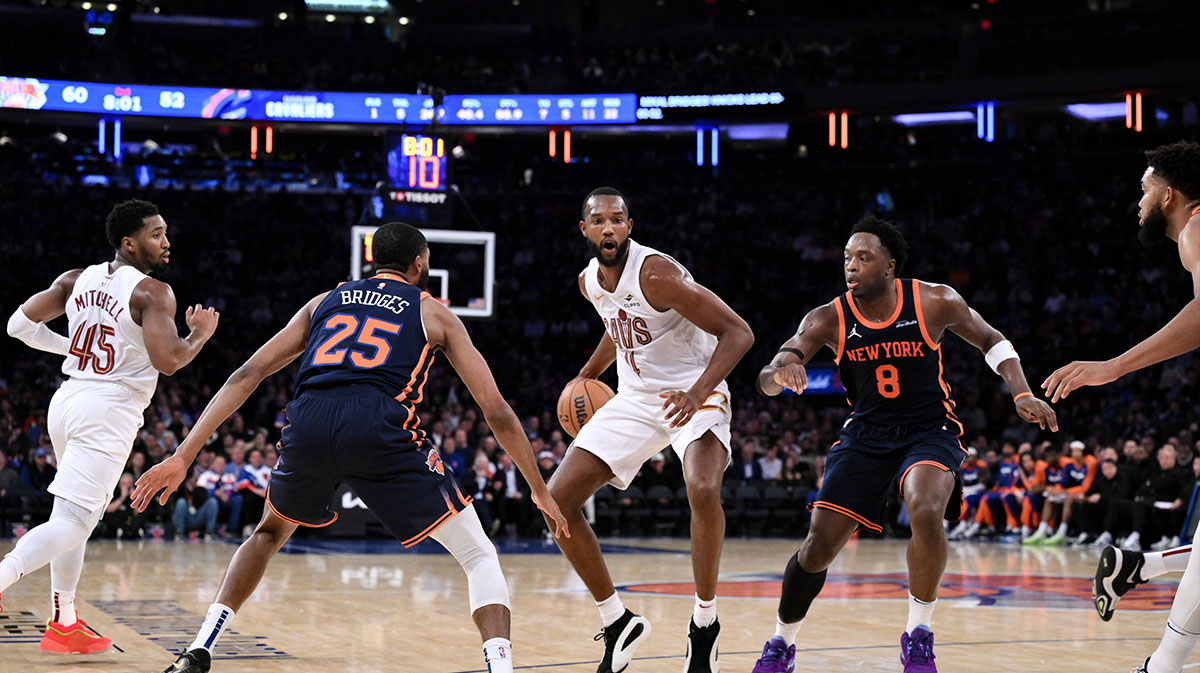 Cleveland Cavaliers forward Evan Mobley (4) drives to the basket while being defended by New York Knicks forward Mikal Bridges (25) and New York Knicks forward OG Anunoby (8) during the second half at Madison Square Garden