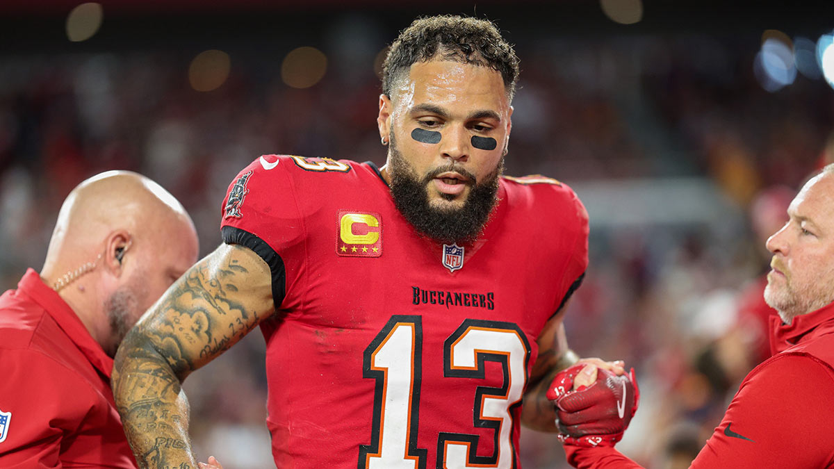 Tampa Bay Buccaneers wide receiver Mike Evans (13) is helped off the field by trainers against the Baltimore Ravens in the second quarter at Raymond James Stadium.