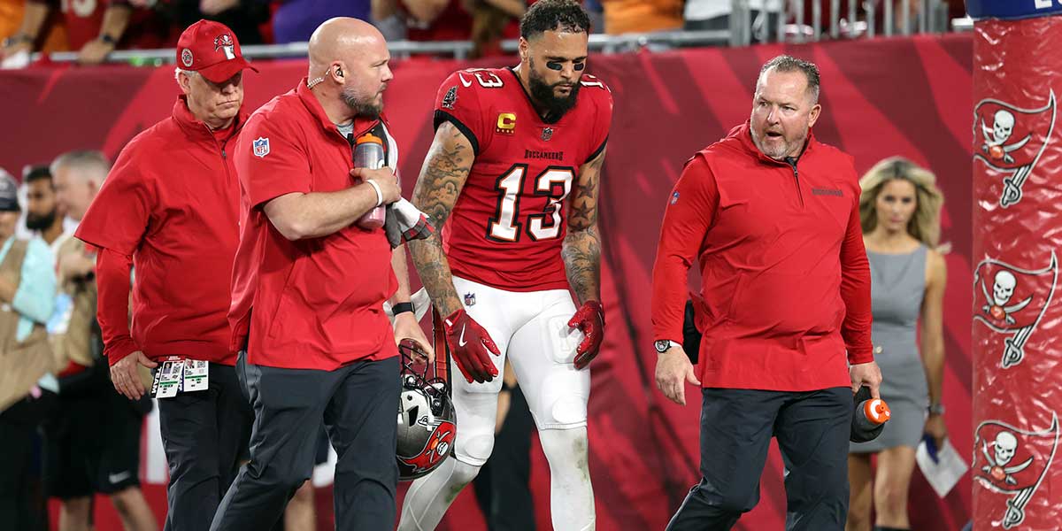 Tampa Bay Buccaneers wide receiver Mike Evans (13) leaves the game after an apparent injury against the Baltimore Ravens during the first half at Raymond James Stadium.