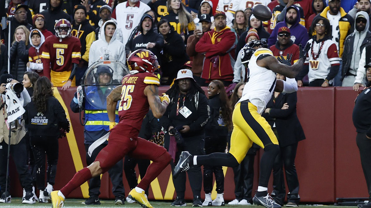 Pittsburgh Steelers wide receiver Mike Williams (18) catches a touchdown pass as Washington Commanders cornerback Benjamin St-Juste (25) defends late in the second half at Northwest Stadium.