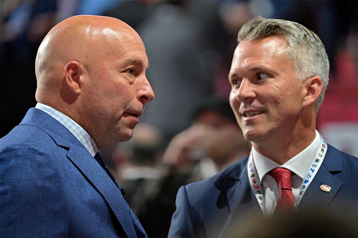 Montreal Canadiens general manager Kent Hughes (left) talks with head coach Martin St. Louis before the first round of the 2022 NHL Draft at Bell Centre.