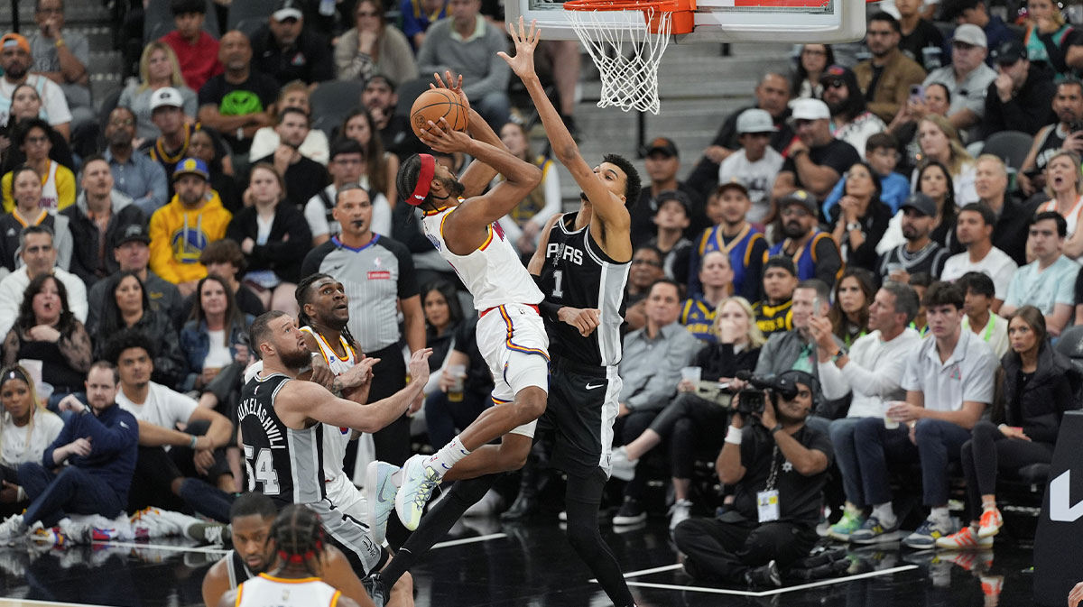 Golden State Warriors guard Moses Moody (4) goes up against San Antonio Spurs center Victor Wembanyama (1) in the second half at Frost Bank Center.