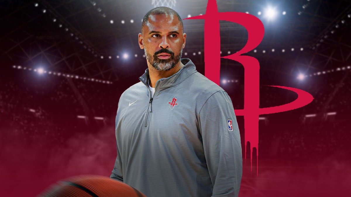 Ime Udoka in Rockets gear next to Rockets logo