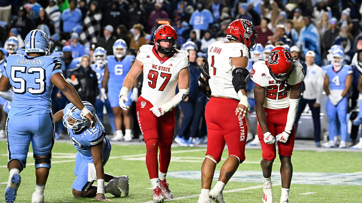North Carolina State Wolfpack cornerback Jackson Vick (22) celebrates with defensive end Davin Vann (1) after sacking North Carolina Tar Heels quarterback Jacolby Criswell (12) leaving 7 seconds in the fourth quarter at Kenan Memorial Stadium.