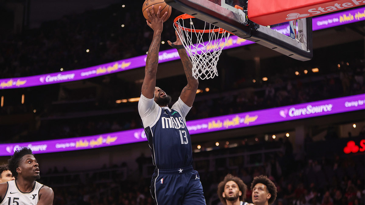 Dallas Mavericks forward Naji Marshall (13) shoots against the Atlanta Hawks in the first quarter at State Farm Arena.