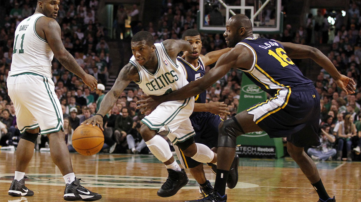 Boston Celtics point guard Nate Robinson (4) breaks through the defense of Utah Jazz center Francisco Elson (16) and point guard Ronnie Price (17) during the second half at the TD Garden. The Celtics defeated the Utah Jazz 110-86.