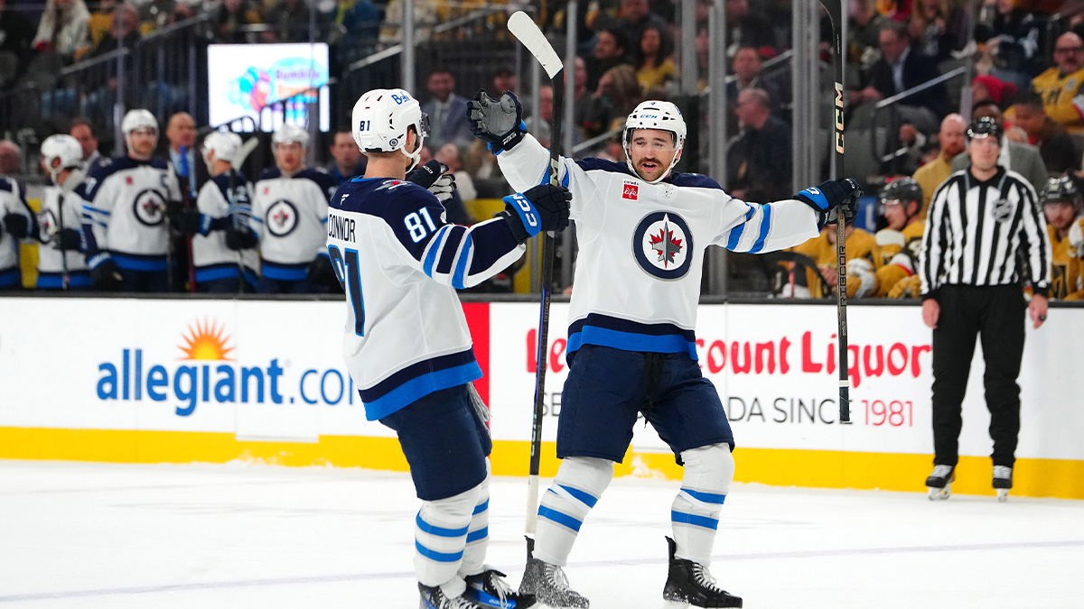Winnipeg Jets defenseman Neal Pionk (4) celebrates with Winnipeg Jets left wing Kyle Connor (81) after scoring a goal against the Vegas Golden Knights during the third period at T-Mobile Arena.
