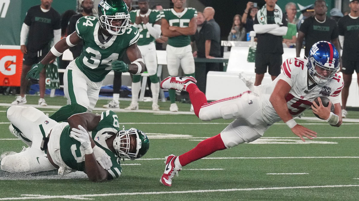 Tanzel Smart of the Jets trips up Tommy DeVito of the Giants just short of a first down on a fourth down play at the end of the game. The New York Giants and New York Jets meet at MetLife Stadium in the final preseason game of the 2024 season for both teams.