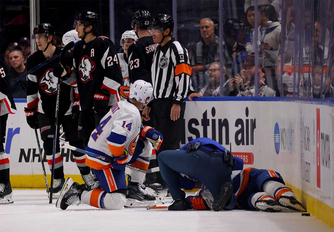 Trainers attend to New York Islanders defenseman Mike Reilly (2) after getting hurt during the second period against the Buffalo Sabres at KeyBank Center.