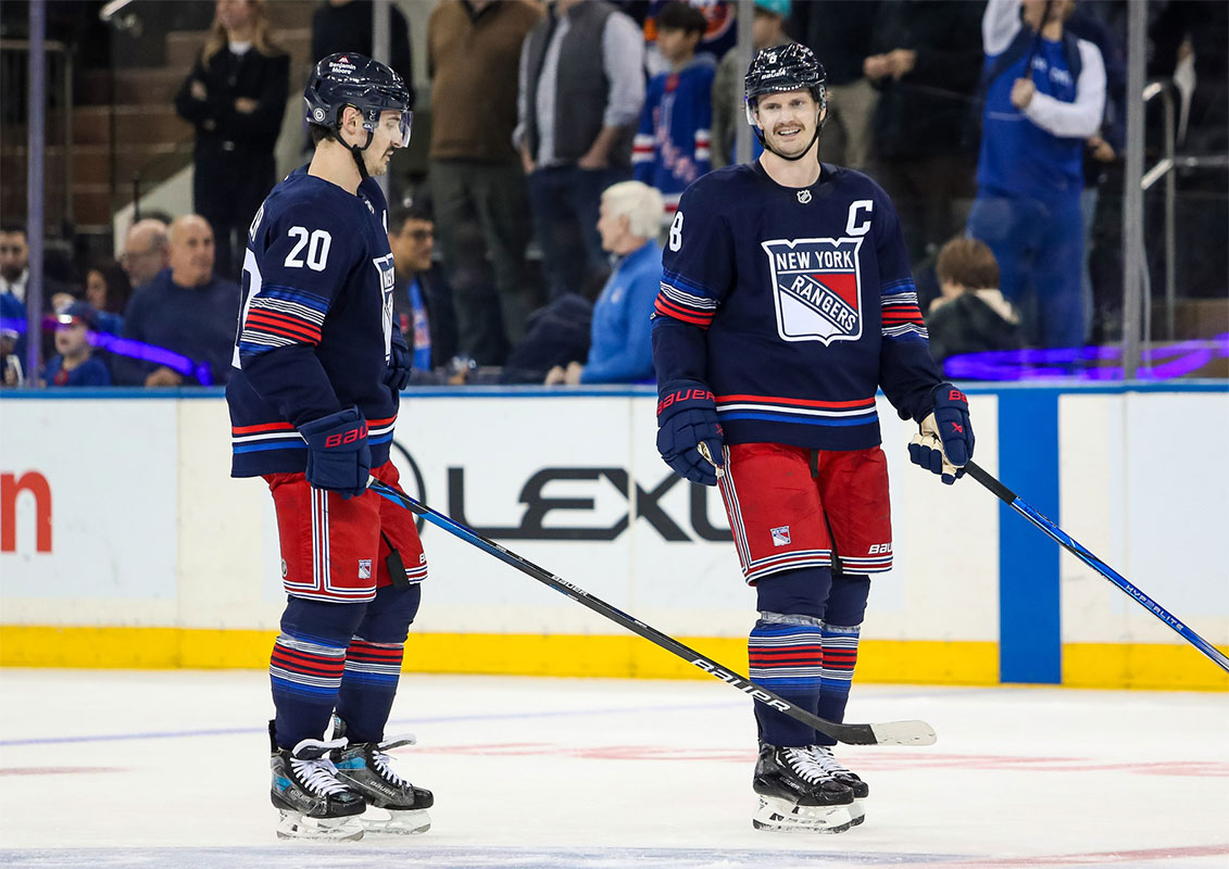New York Rangers defenseman Jacob Trouba (8) and left wing Chris Kreider (20) celebrate a win against the New York Islanders at Madison Square Garden.