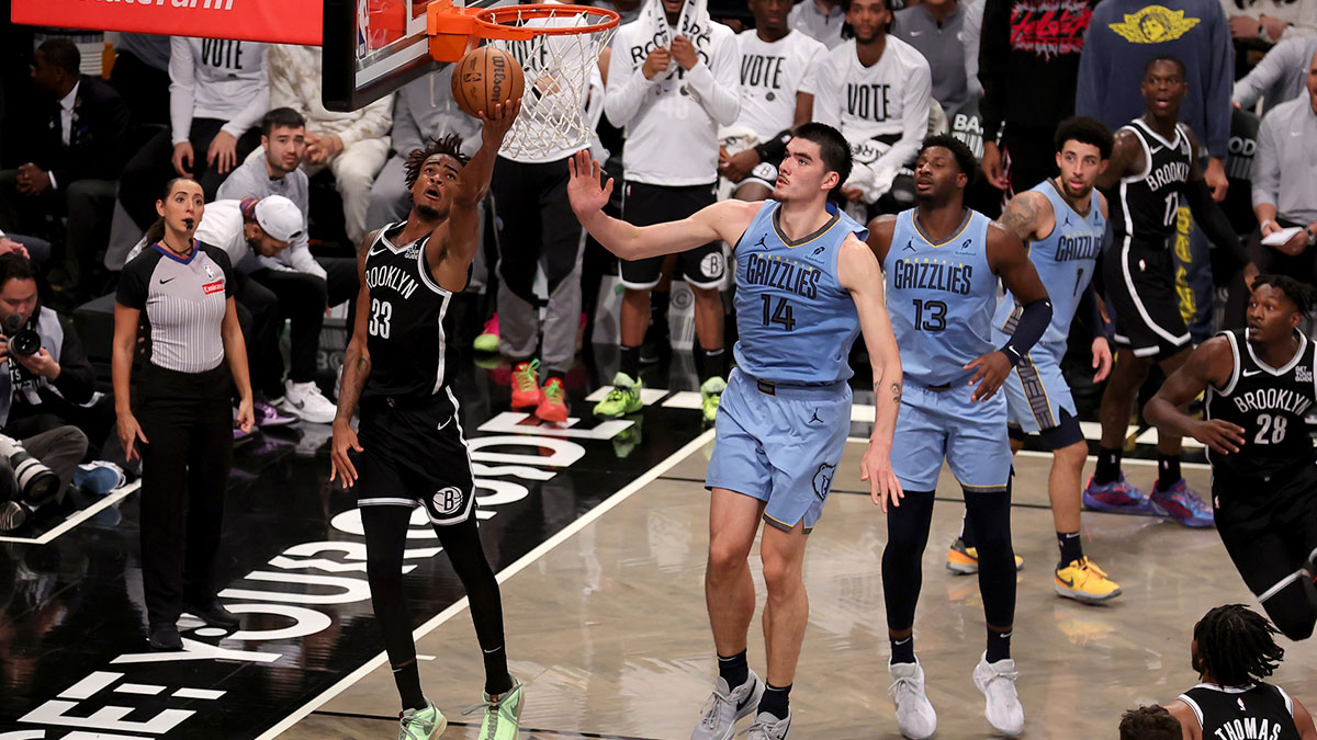 Brooklyn Nets center Nic Claxton (33) drives to the basket against Memphis Grizzlies center Zach Edey (14) and forward Jaren Jackson Jr. (13) and guard Scotty Pippen Jr. (1) during the fourth quarter at Barclays Center.