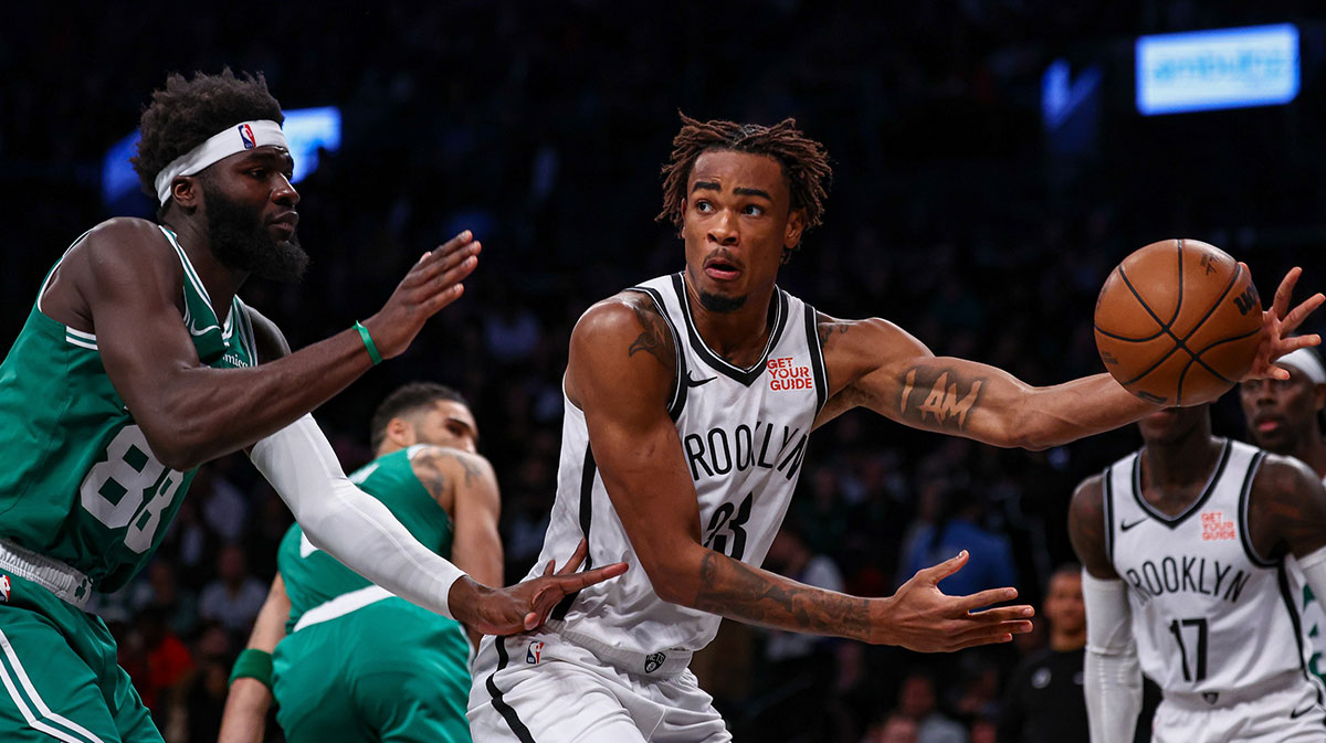 November 13, 2024; Brooklyn, New York, USA; Brooklyn Nets center Nick Claxton (33) passes the ball as Boston Celtics center Nehemiah Keta (88) defends during the second half at Barclays Center. Mandatory credit: Vincent Carchietta-Imagn Images