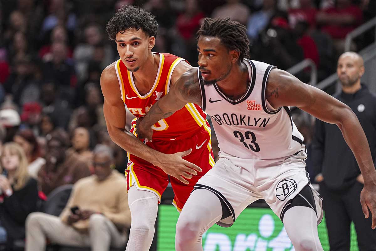 Atlanta Hawks forward Zaccharie Risacher (10) tries to get position on Brooklyn Nets center Nic Claxton (33) during the second half at State Farm Arena.