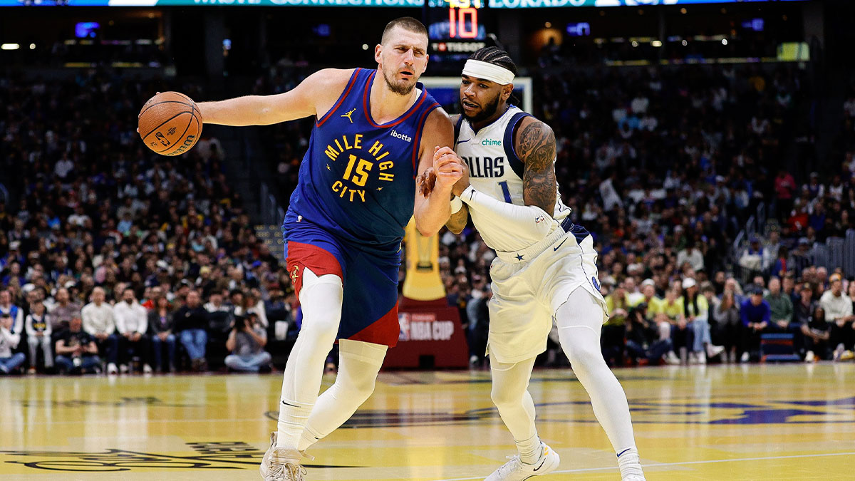 Denver Nuggets center Nikola Jokic (15) controls the ball under pressure from Dallas Mavericks guard Jaden Hardy (1) in the first quarter at Ball Arena. 