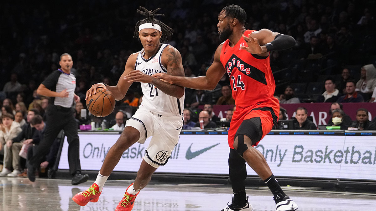 Brooklyn Nets Forward Noah Clovey (21) drives the ball against Toronto Raptor in front of Bruno Fernanda (24) during the first half in the center of Barclays.