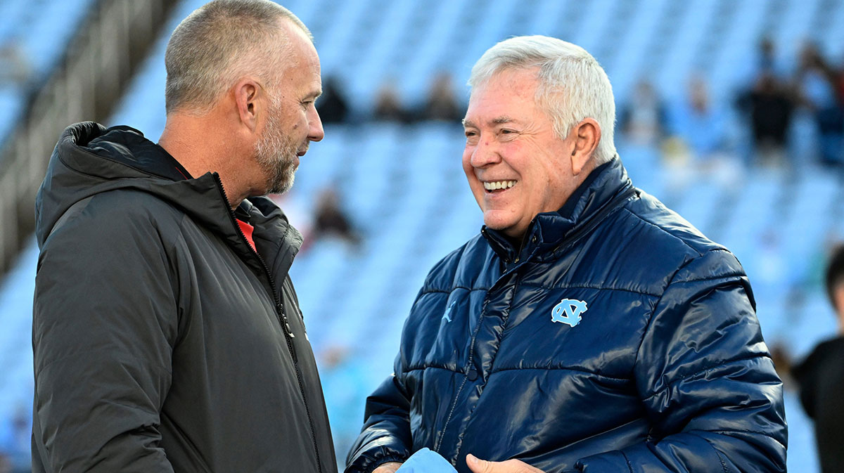NC State football head coach Dave Doeren with North Carolina football head coach Mack Brown before the game at Kenan Memorial Stadium.