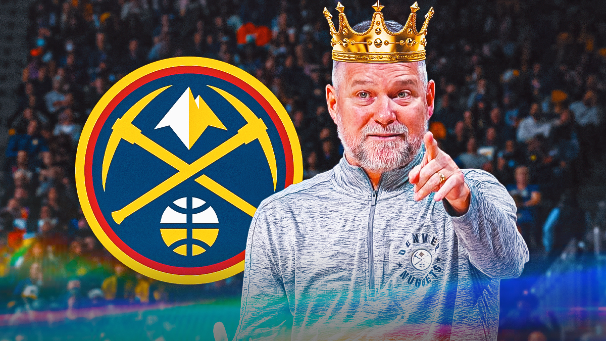 Michael Malone smiling or happy and wearing a crown. Have the Denver Nuggets logo next to him.