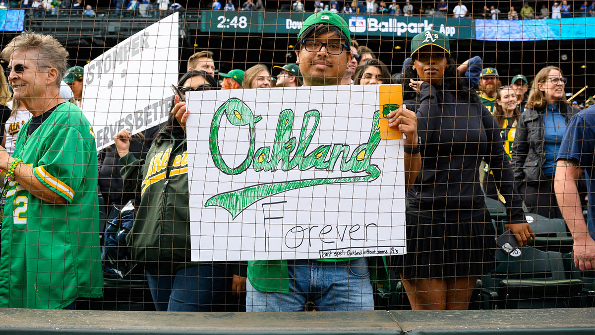 An Oakland Athletics fan holds a sign after the game between the Seattle Mariners and the Oakland Athletics at T-Mobile Park. 